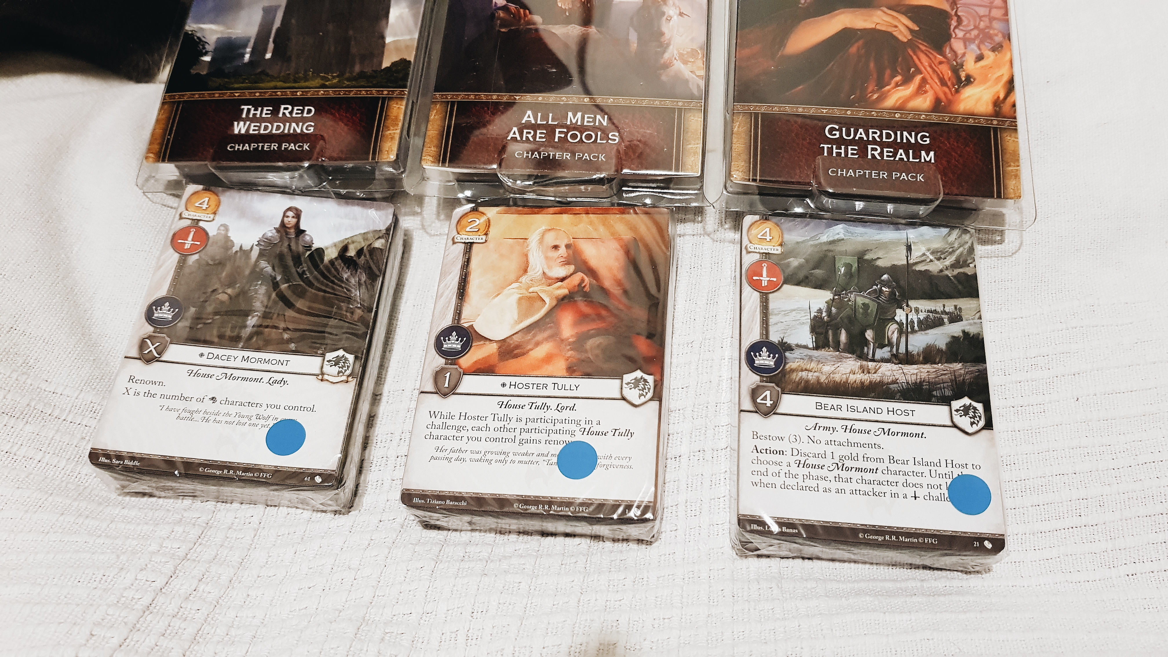The Red Wedding, All Men Are Fools, and Guarding The Realm expansion packs for the Game of Thrones Card Game Second Edition