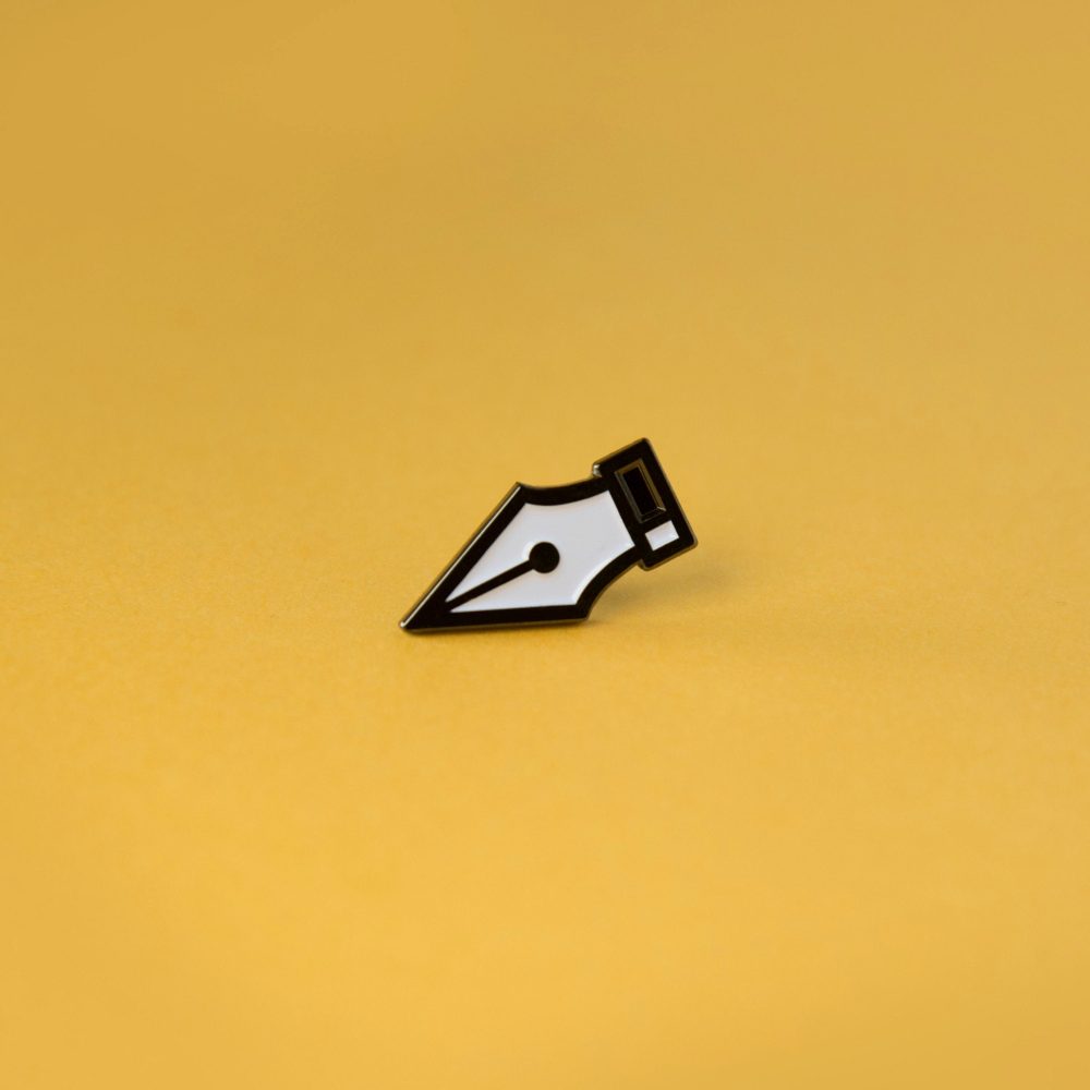 A photo of an enamel pin badge that resembles the pen option in design tools