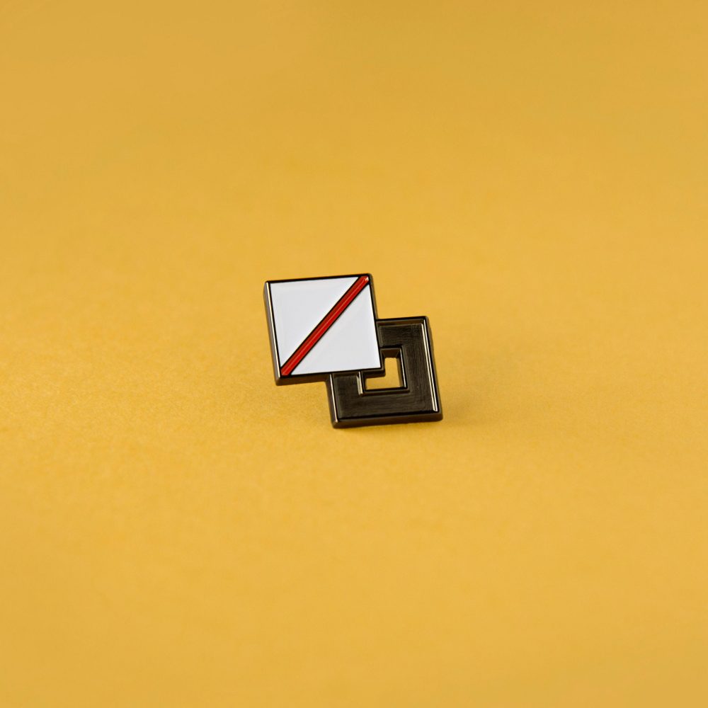 A photo of an enamel pin badge that resembles the palette option in design tools